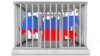 Russia – Sanctions. Map of Russia in Metal Cage with Lock on a white background 