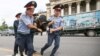 Kazakhstan - Police officers detain an opposition supporter during a protest against presidential election results, in Almaty, Kazakhstan, June 10, 2019. REUTERS/Pavel Mikheyev